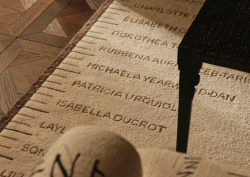 STARK rug designed by Spinocchia Freund. Cream rug with names of female designers and artists listed along the edge