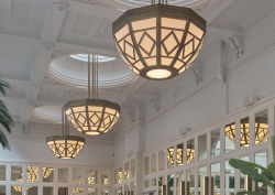 Tall panelled ceiling in white with structural pendants and mirrored walls