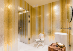 Gold and silver mosaic in bathroom. Gold drips down towards floor. By Orsoni mosaics
