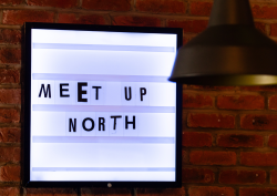 MEET UP North text in cut out newspaper style font on light box