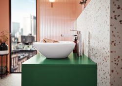 green bathroom vanity with terrazzo surface and pink walls in bathroom trends for 2024 from GROHE