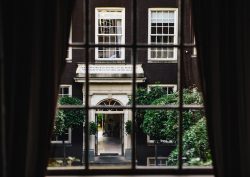 view of hotel entrance through curtains and window at The dylan amsterdam