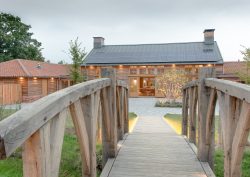 wooden bridge at Retreat East heading towards the Great Barn