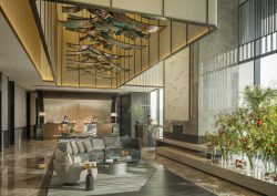 Four Seasons Hangzhou at Hanzhou Centre lobby space is a large are with huge double-height windows and polished stone flooring