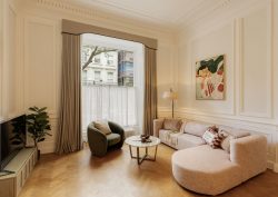 cream couch on wooden floor in front of period style London window