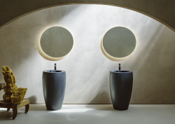 two round wall mirrors above two frreestanding basin units from Laufen