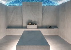 heated stone treatment bed with blue mosaic ceiling in The Newt