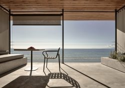 chair and table silhouetted against ocean view in Dexamenes Seaside Hotel