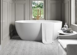 freestanding acrylic bath in a grey panelled bathroom with french sash windows. Bath by Lusso