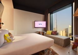 Mama Shelter guestroom with view over Dubai skyline from the bed