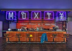 Moxy Bar in Chongqing with neon writing and orange tiled surfaces