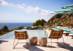 deckchairs and umbrellas by pool with seaview at Nammos Mykonos