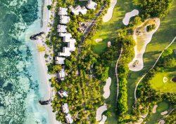 Arial view of Paradis Beachcomber in Mauritius. The image shows both above-shots of villas and the clear blue sea