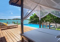 deck, pool and sunlounger overlooking the sea at The Tongsai Bay