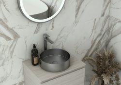 RAK round brushed nickel basin in marble tiled bathroom