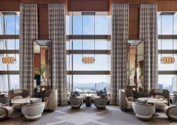 tub chairs around tables in lobby and lounge area of Ritz Carlton tokyo with view over city