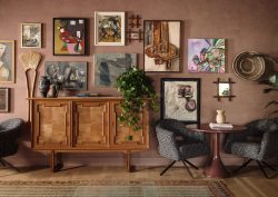 vintage cabinet and a gallery of local art in the hotel lobby of ROOST Rainey