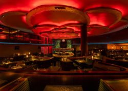 Rockwell Group design for _COTE Vegas_with red logo and ceiling lighting