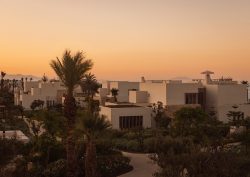 sunset and palm trees over Royal Mansour Tamuda Bay
