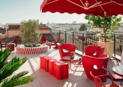 roof terrace at Ruby Giulia Rome with red parasols and chairs