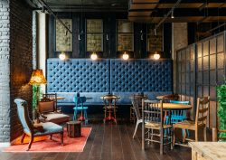 blue banquette and eclectic wooden chairs in Ruby Molly Dublin
