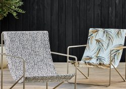 metal deck chairs on wooden deck covered in Harlequin outdoor fabric