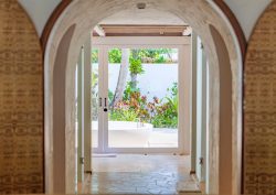 doors and arches leading from bedroom to outdoor bathroom at Sirru Fen Fushi