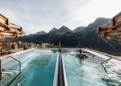 person swimming in rooftop pool in mountain chalet, BelArosa Chalet