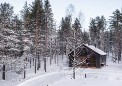 log cabin in snow and woods - Skyra retreat log suite