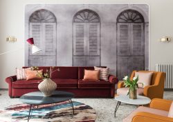 rust and mustard couch and chairs in front of faded mural of roman facade in THDP apartment Piazza Navona