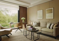 sofa, chair and table in muted natural colours in the balcony suite of The Emory Hotel London