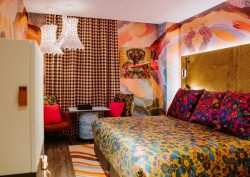 checked curtains, floral bedcover and pattern wallpaper in The-Motley-Hotel-Richmond-Tapestry-Collection-by-Hilton-Guest-Room