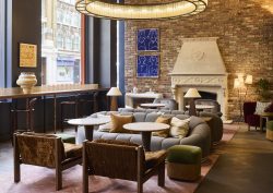 seating by fireplace in The Hoxton Shoreditch lobby