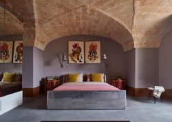 guestroom in Tower Elvira with stone arches and bespoke metal bed