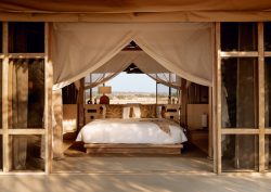 view of bed in tented guestroom at Ubuyu from Banyan Group