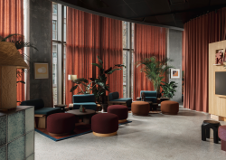rust and brown seating and curtains in lobby of Locke Copenhagen designed by A-nrd