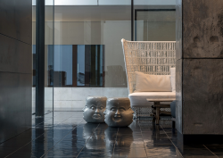woven chair and ceramic face in the lobby of COMO Metropolitan Bangkok