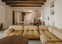 deep buttoned couch and wooden table in public area of a Highstay luxury apartment