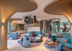 lobby with blue furniture and lily pad columns in Sentosa Cove as it lifts the curtain on its newly reimagined rooms and suites