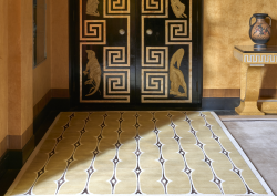 Pelican carpet rug on the floor with ochre walls and decorative door