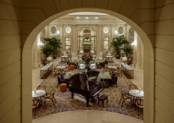 view through arch onto the grand staircase in Corinthia Brussels