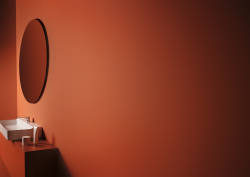 conca mirror from Ideal Standard on rust painted wall