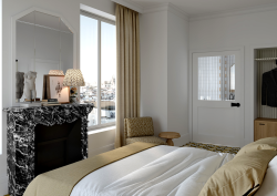 fireplace next to window in guestroom of Noucha boutique hotel in 16th arrondissement Paris