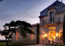 entrance to COMO Cordeillan-Bages lit up at night