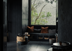black walls and floors with view over rainforest at Silverback Lodge, Uganda