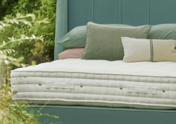 Close up shot of Hypnos Wild Cornwall bed, part of the Eden Project collaboration. Surrounded by wildflower greenery