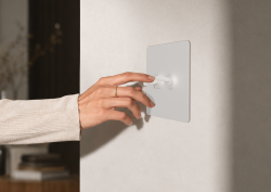 hand on repenic switch in hotel guestroom