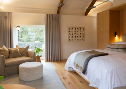 Fowlescombe Farm guestroom with view to countryside and farm