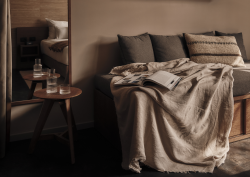 couch with cushions, book and blanket in natural colours in Casa Cook Madonna