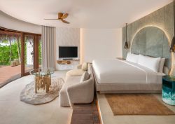 white and natural bedroom design in beach villa with driftwood table W Maldives